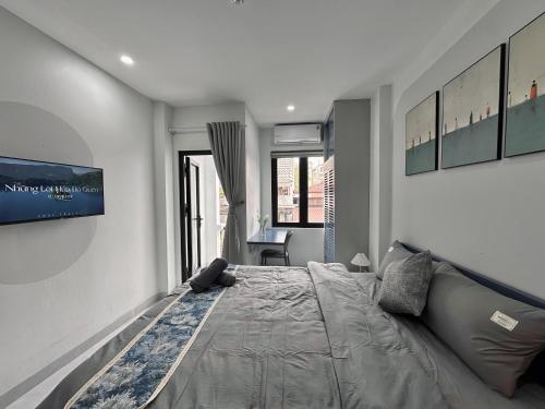 a bedroom with a large bed and a desk at The Little Hanoi - Cool Apartment - Lakeside in Hanoi