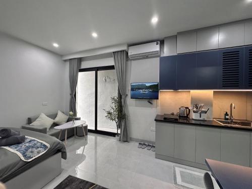 a kitchen and living room with a bed and a couch at The Little Hanoi - Cool Apartment - Lakeside in Hanoi