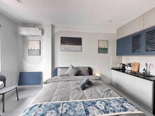 a bedroom with a large bed and a table at The Little Hanoi - Cool Apartment - Lakeside in Hanoi