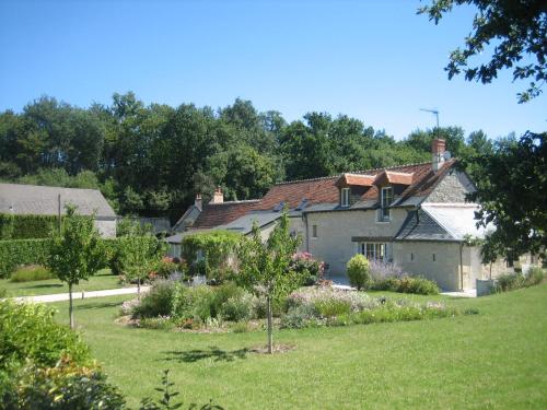 an old house with a garden in the foreground at Villa - La chambre des Dames in Vallères