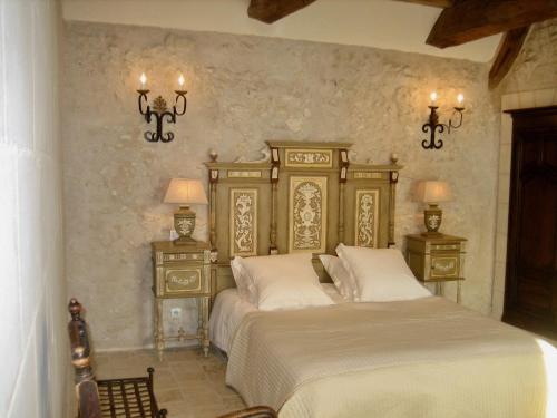 a bedroom with a bed and two night stands at Villa - La chambre des Dames in Vallères