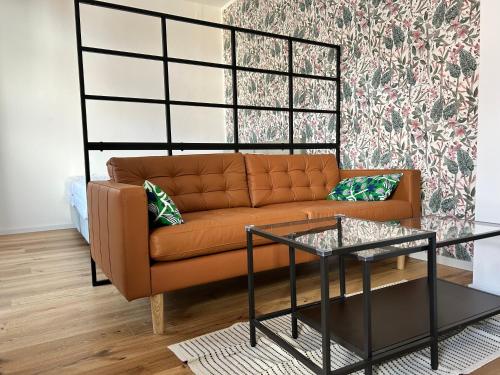 a living room with a couch and a table at Studio am Hafen in Klagenfurt
