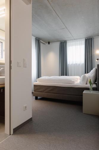 a bedroom with a large bed and a window at Baltica Hamburg Altona in Hamburg