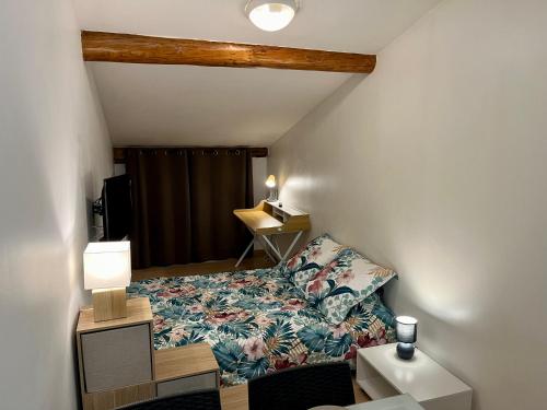 une petite chambre avec un lit et un bureau dans l'établissement Magnifique appartement, au Puy-en-Velay