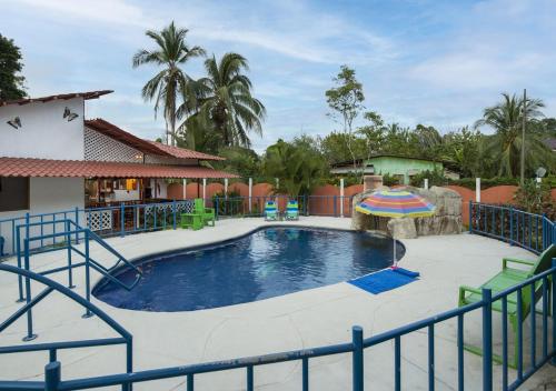 a large swimming pool with a slide in a yard at Entire Home Near Beach, Quiet Area, Pool in Manzanillo