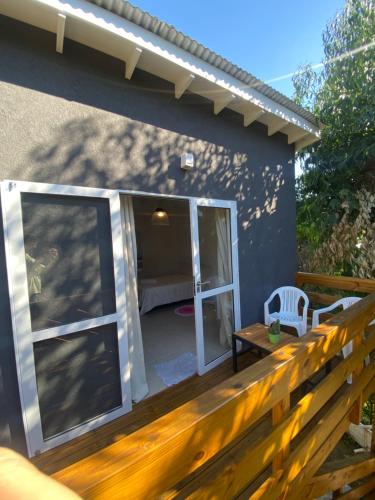a deck with a sliding glass door on a house at Entre Verdes in Valeria del Mar