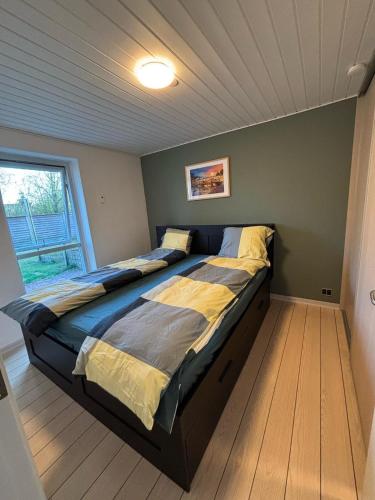 a large bed in a room with a window at Home in Billund in Billund