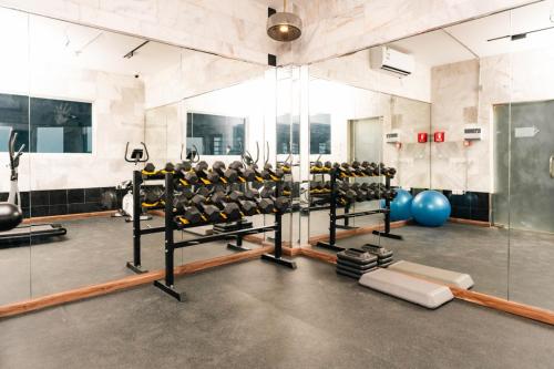 a gym with a lot of equipment in a room at Aluya Hotel in Jeddah