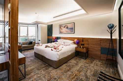 a hotel room with a bed and a couch at Aluya Hotel in Jeddah