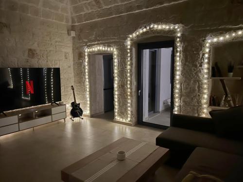 een woonkamer met lampen aan de muren en een tafel bij Lamia Al Mar in Torre Canne