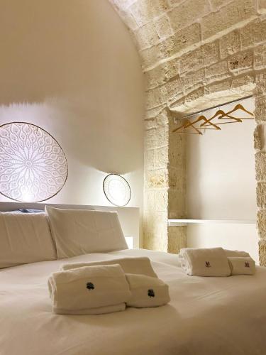 a bedroom with a large white bed with two pillows at Lamia Al Mar in Torre Canne