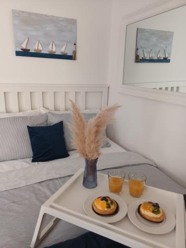 a table with two plates of pancakes and two glasses of orange juice at App Hedonist in Novigrad Istria