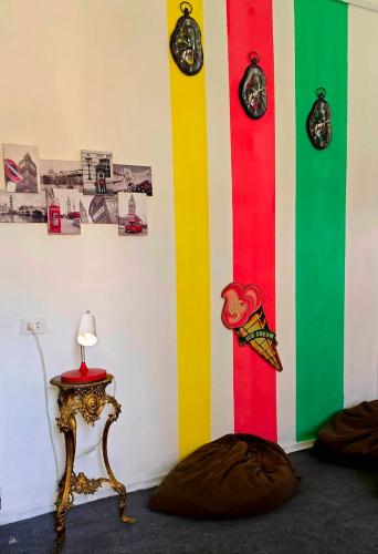 a room with a colorful wall with clocks on it at Colors Hostel in Tbilisi City