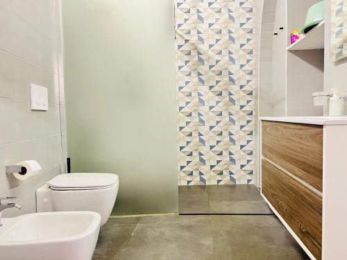 a bathroom with a toilet and a sink at "Sweet Life" Casa Vacanze in Lipari