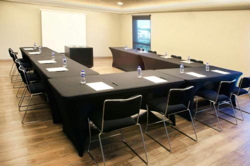 a large meeting room with a long table and chairs at City Express Plus by Marriott Tampico in Tampico