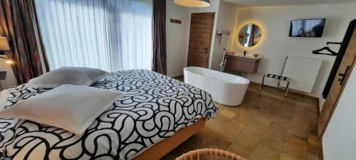 a bathroom with a large bed and a bath tub at " NEW 2025 " Plein Vent 800m entrée Combes circuit Spa Francorchamps in Francorchamps