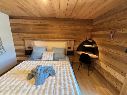 a bedroom with a bed in a wooden cabin at Lumen Wood in La Bresse