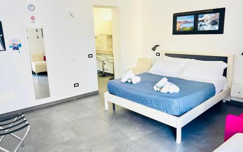 a bedroom with a bed with two towels on it at "Sweet Life" Casa Vacanze in Lipari