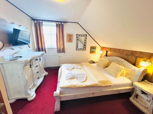 a bedroom with a bed and a desk in it at Pension Aja in Ždiar