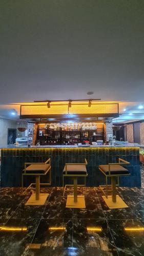a restaurant with four tables and a bar at Bianco Beach Hotel in Kusadası