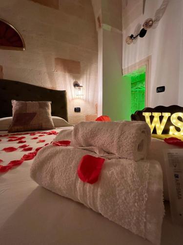 a hotel room with towels on a bed at Wine Suite in Torricella