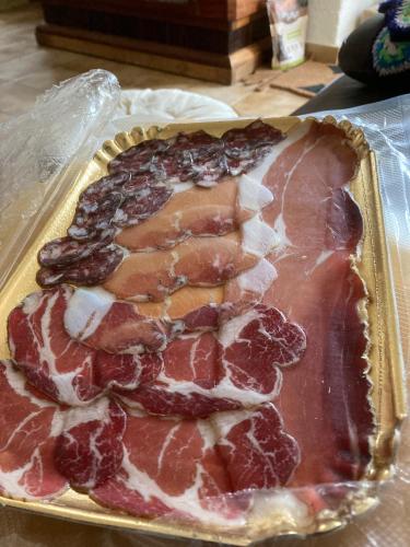 a tray of meat on top of a table at Solacargese Appartement de charme Vue imprenable Méditerranée in Cargèse