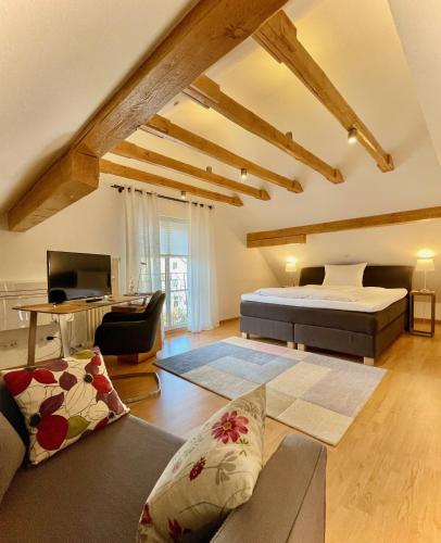 a bedroom with a bed and a living room at Gästehaus No. 3 in Simmern