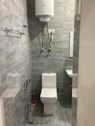 a bathroom with a toilet and a sink at Visiting Villa in Srinagar