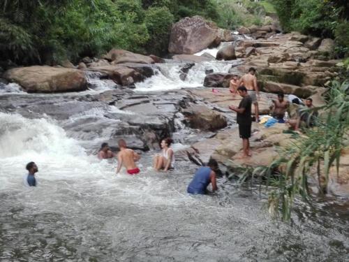 a group of people swimming in a river at The River Hut Resort Hatton in Hatton
