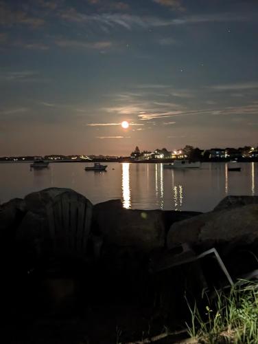 a view of a body of water at night at Beach Cottage in Saco