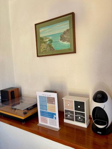 a wooden shelf with two electronics on top of it at La casetta di Tato in Monterosso al Mare