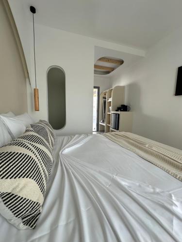 a large white bed in a white room at Marjay Boutique in Parikia
