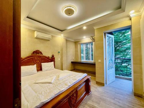 a bedroom with a large bed and a window at DL Homestay in Phnom Penh