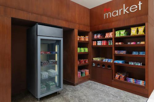a grocery store with a refrigerator in a store at Fairfield by Marriott Amritsar in Amritsar