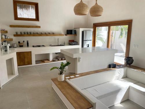 a kitchen with white counters and a white counter top at Mahalo Villa Selva with Private Pool in Popoyo