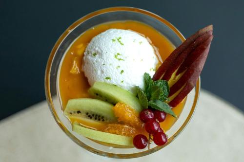 a bowl of food with fruit and ice cream at Courtyard by Marriott Biel Bienne in Biel