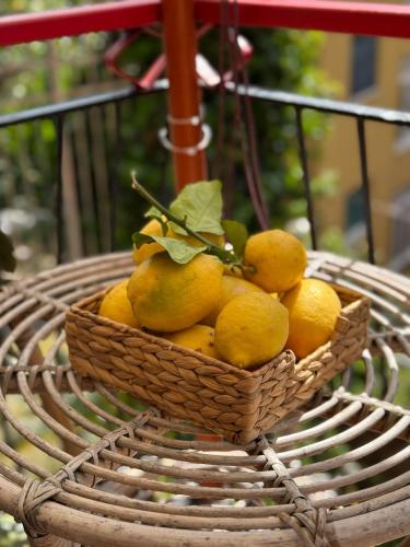 a basket of lemons sitting on top of a table at La casetta di Tato in Monterosso al Mare