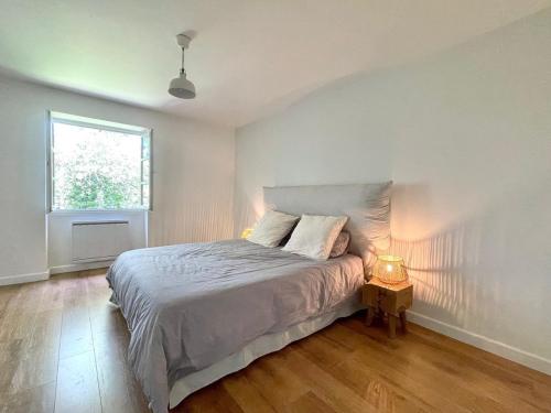 a bedroom with a large bed and a window at La Simone in Richerenches