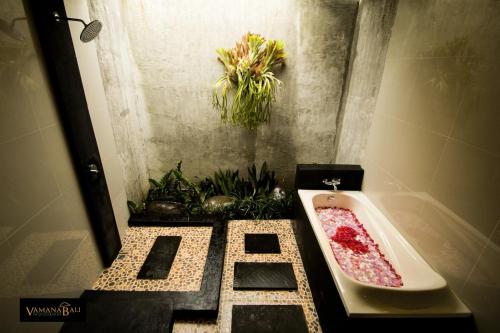 a bathroom with a bath tub with potted plants at The Forest Villa Ubud in Ubud
