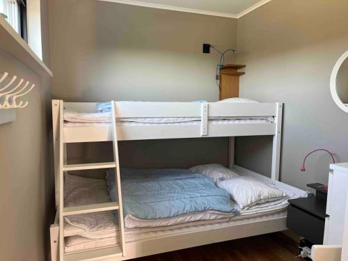 two bunk beds in a small room with at Stuga Varberg Södranäs in Varberg