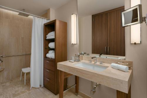 a bathroom with a large sink and a television at The Santa Maria, a Luxury Collection Hotel & Golf Resort, Panama City in Panama City
