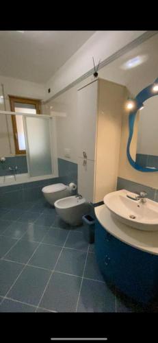 a bathroom with two sinks and two toilets in it at AF Apartments FaraOne in Bari