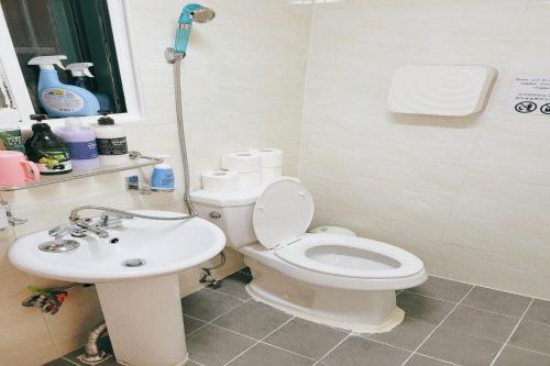 a bathroom with a toilet and a sink at Hongdae 3mins, Q House in Seoul