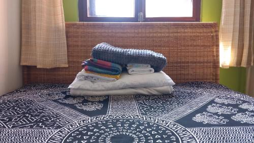 a pile of towels sitting on top of a bed at Kisfaludy Apartment House in Gárdony