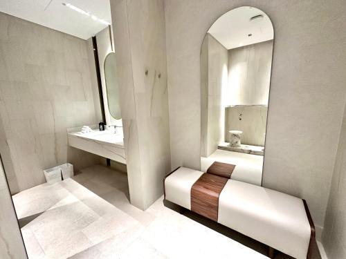 a bathroom with a sink and a mirror at Address Beach Resort Properties Bahrain in Manama