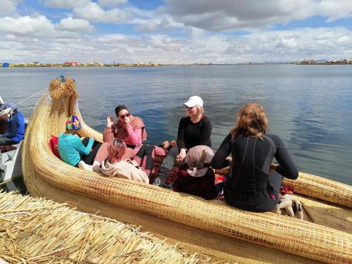 a group of people sitting in a boat on the water at NIDO DEL TITICACA Eco Lodge in Puno