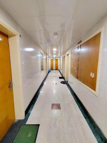 an empty hallway of an office building with a long corridor at Ajman Family AIDEN Premium VIP in Ajman 