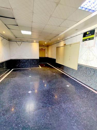 an empty gymnasium with a empty floor and two stalls at Ajman Family AIDEN Premium VIP in Ajman 