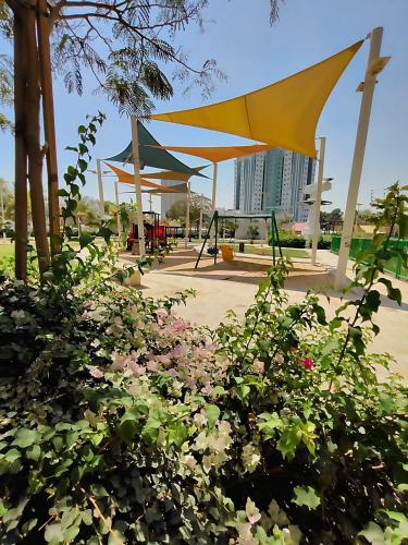 a park with a bunch of flowers in front at Ajman Family AIDEN Premium VIP in Ajman 