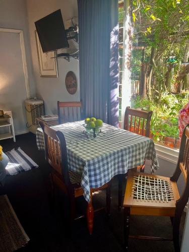 a table with a bowl of fruit on top of it at Glen House in Brenton-on-Sea